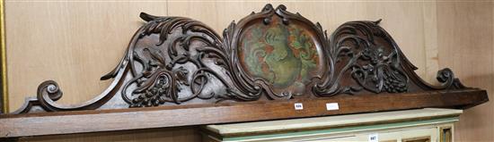 A Victorian carved and painted oak pediment, with central crest, W.203cm